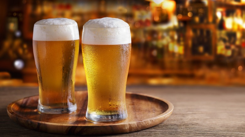 two glasses of beer on bar