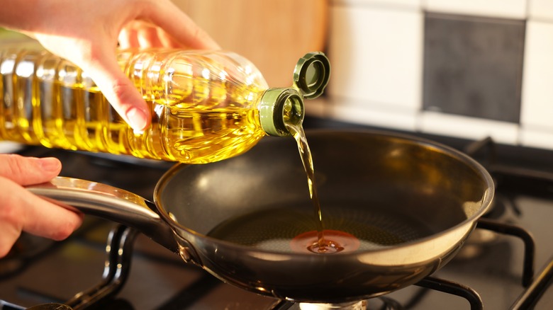 pouring oil into pan