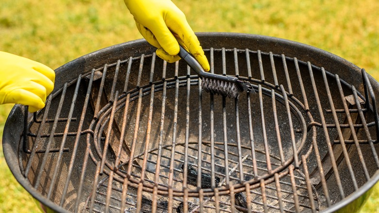 rubber gloves scrubbing grill grate