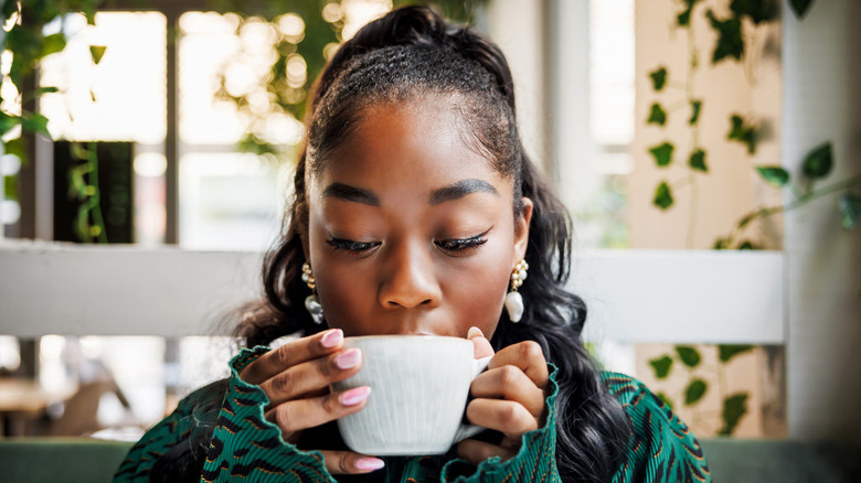 person enjoying cup of coffee