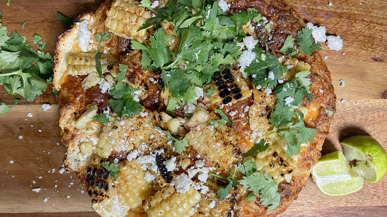 cheesy elotes street corn pizza on cutting board