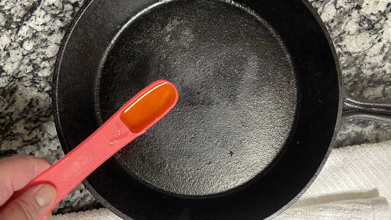 adding oil to cast iron skillet