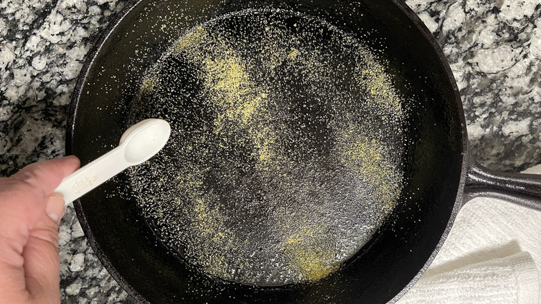 dusting cast iron skillet with cornmeal