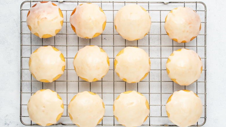 orange muffins with orange glaze on wire rack