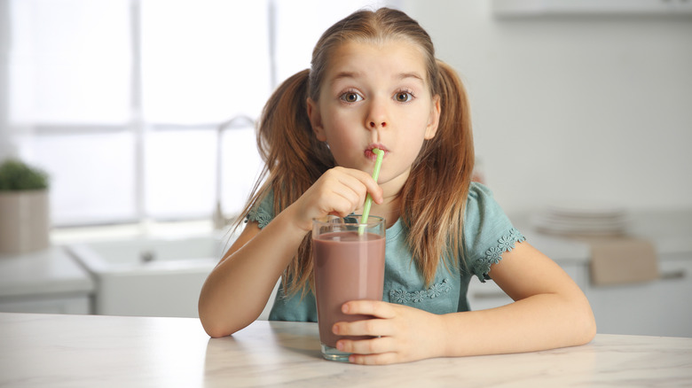 Young girl drinking chocolate milk