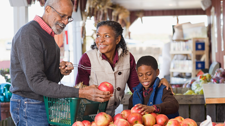 family selecting apples