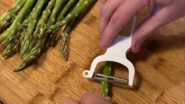 Asparagus being peeled 