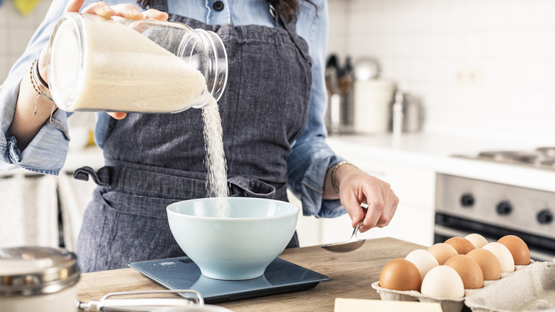 cook measuring ingredients on scales