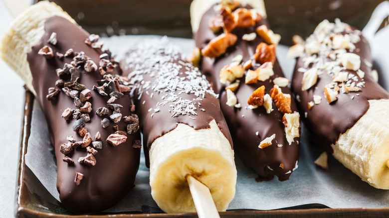 Four chocolate frozen bananas