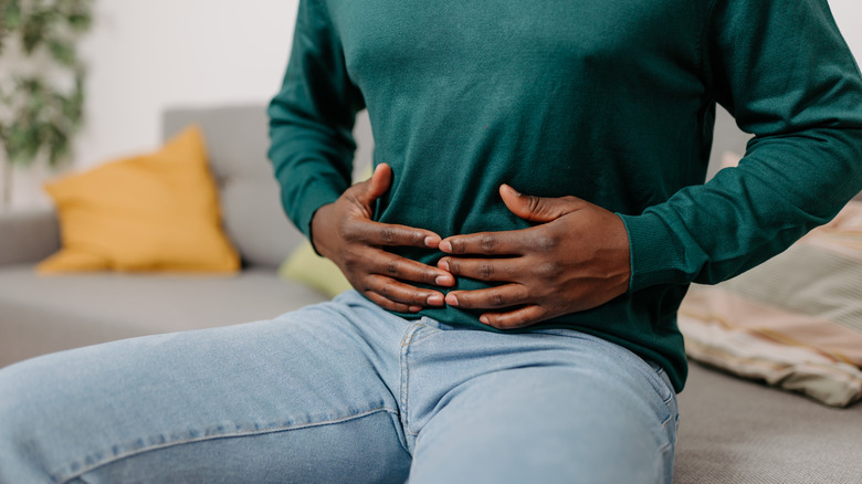 man holding his stomach