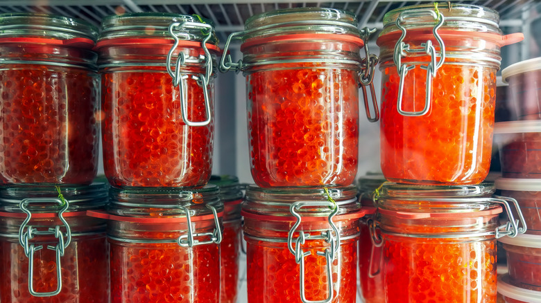 Jars with caviar in fridge