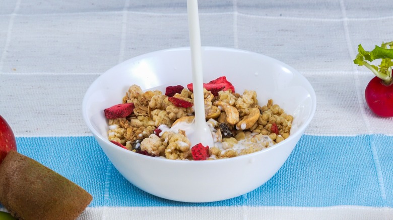 milk pouring into cereal