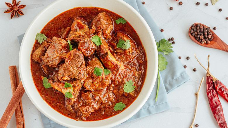 bowl of curry with cinnamon sticks