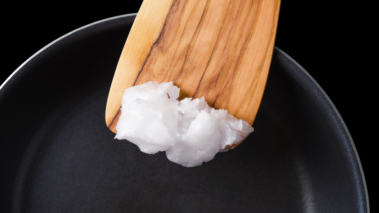 coconut oil going into frying pan