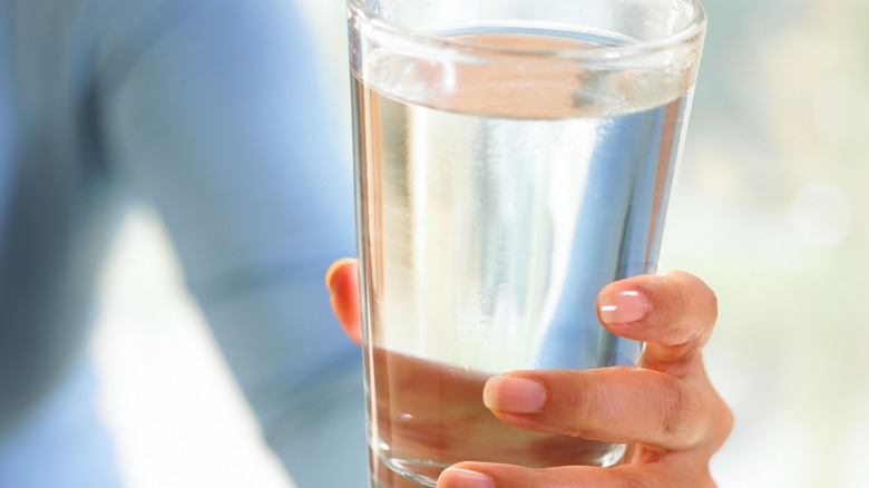 woman holding water glass