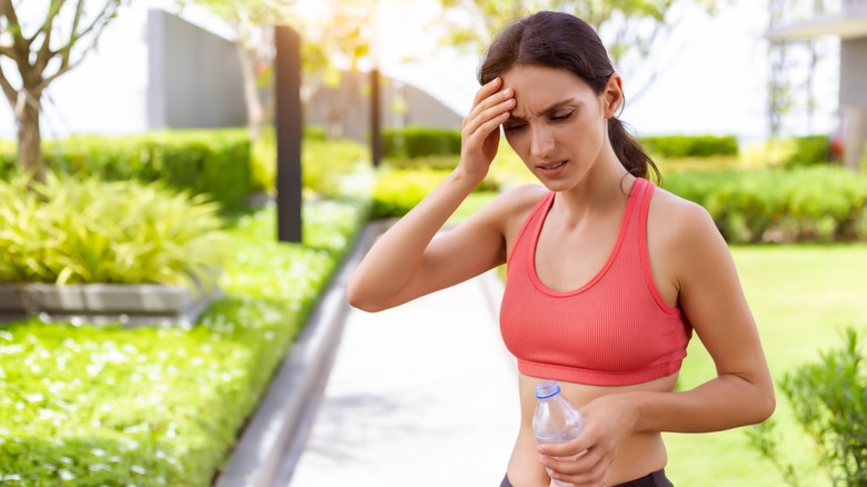 athletic woman holding head