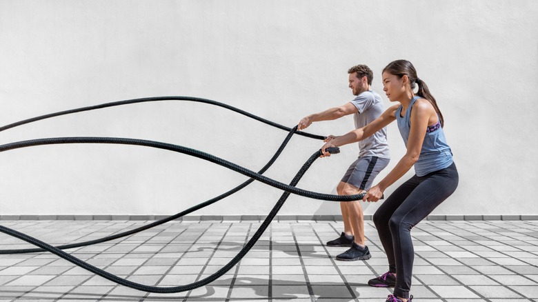 man and woman rope workout