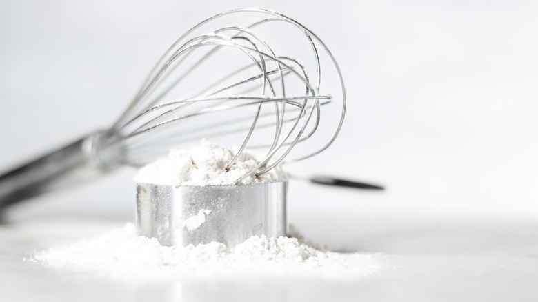 Whisk, flour, and measuring cup