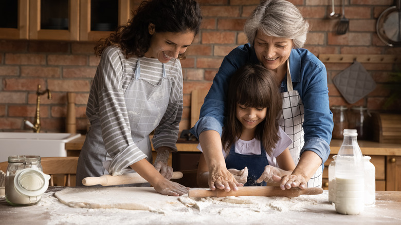 Family making dough from flour