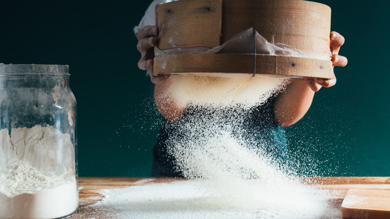 Person sifting flour