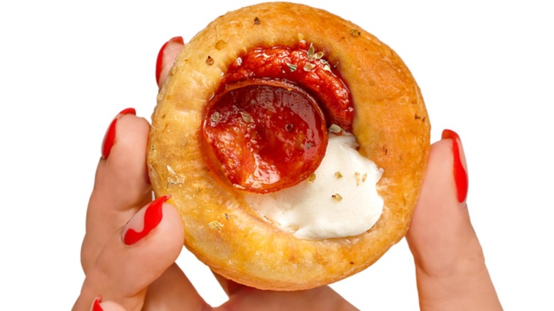 Woman holding pizza cupcake