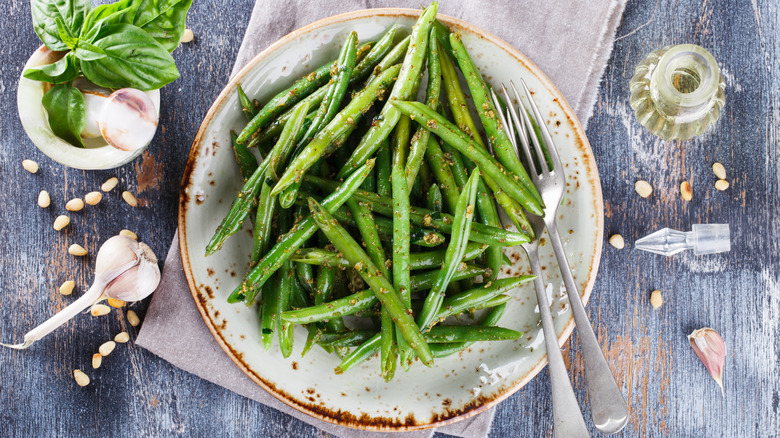 plate of green beans with garlic and basil