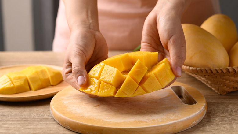 preparing mango on cutting board