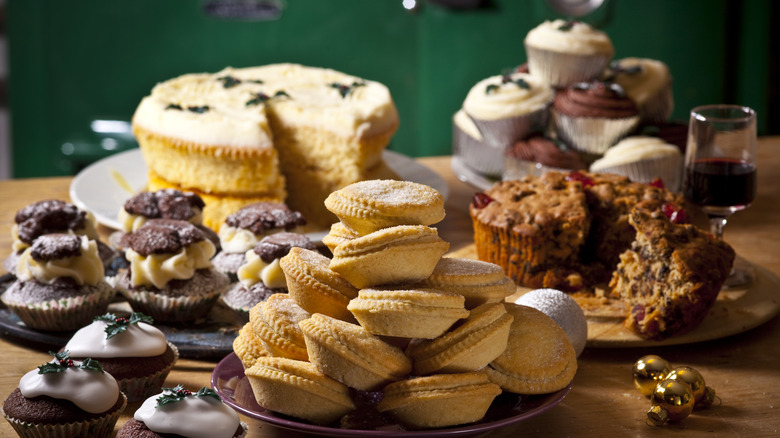 Table full of baked goods of pies, muffins, and cakes