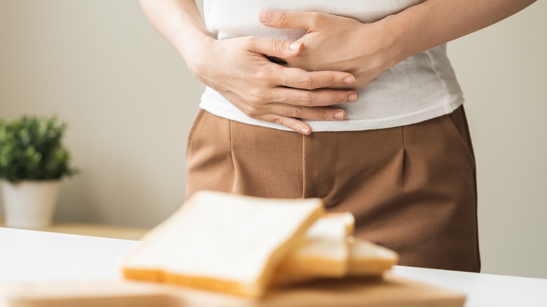 Woman holding stomach in pain