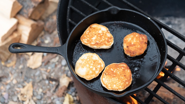 pancakes cooking in cast iron pan