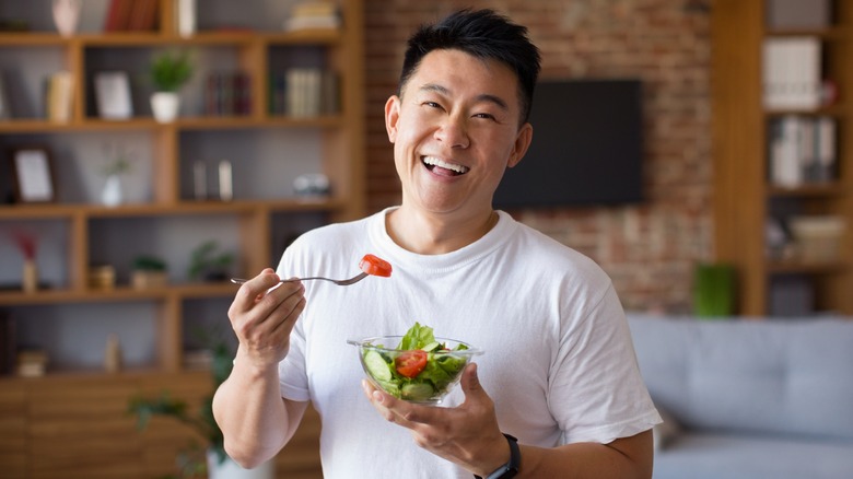 man holding vegetable bowl