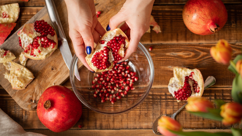 Deseeding pomegranate on a bowl