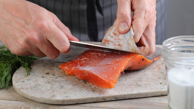 chef removing salmon skin