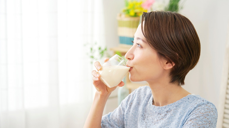 woman drinks soy milk