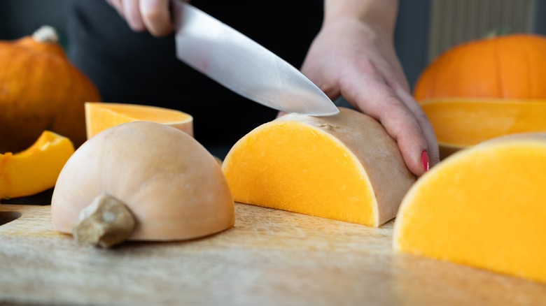 person slicing squash