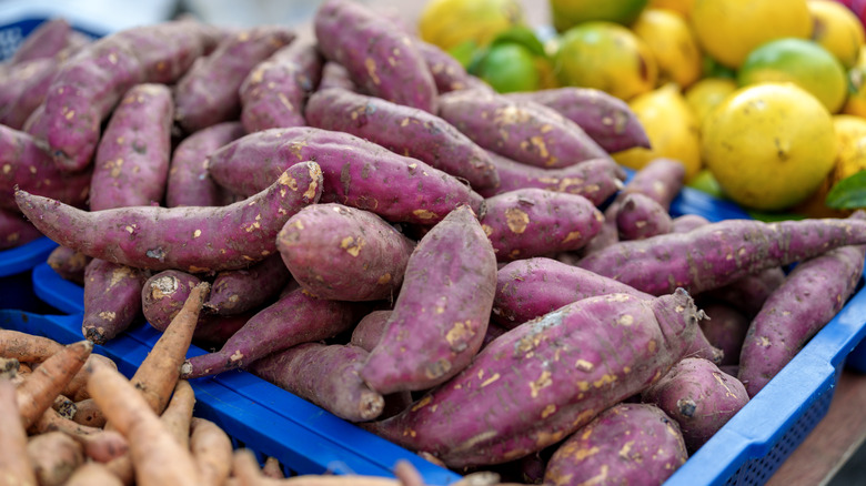 sweet potatoes at farmers market stand