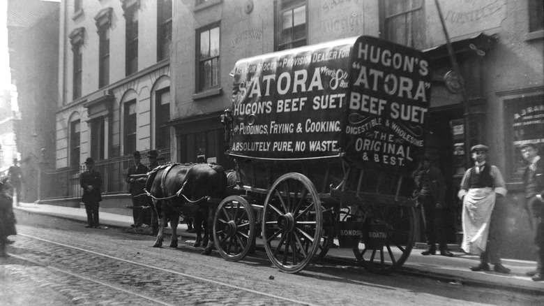 Black and white photo of carriage advertising beef suet 