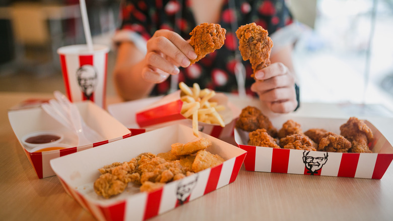 Woman eats KFC fried chicken 