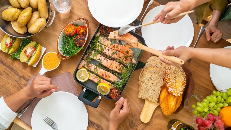 hands serving food on table