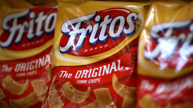 Bags of Fritos on a store shelf