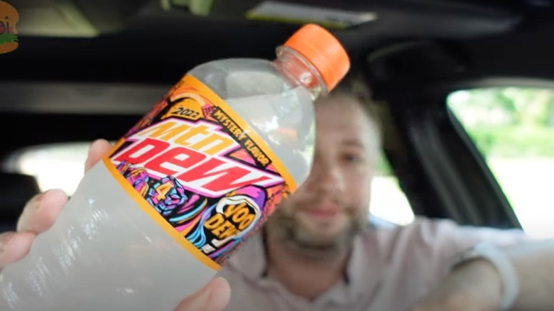 Person holding Mountain Dew VooDEW bottle