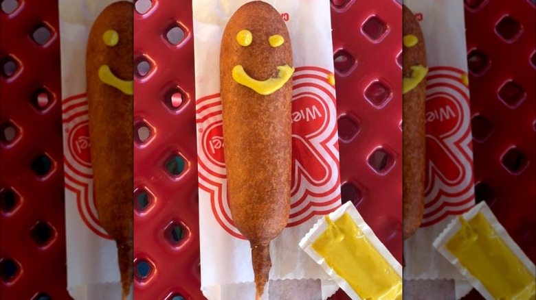 corn dog with mustard smiley face