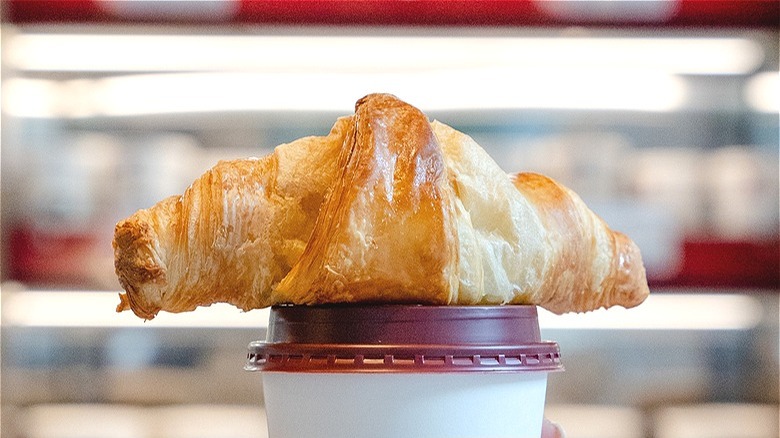 Croissant on coffee cup
