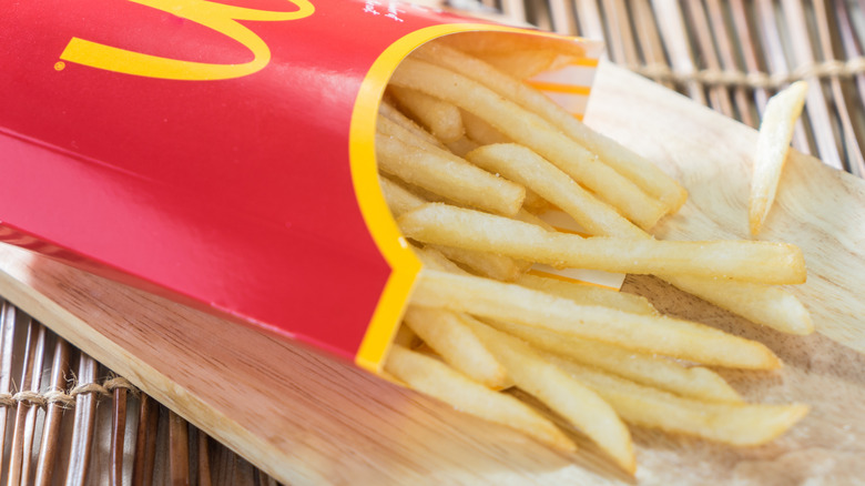 McDonald's fries are spilling out of a box.