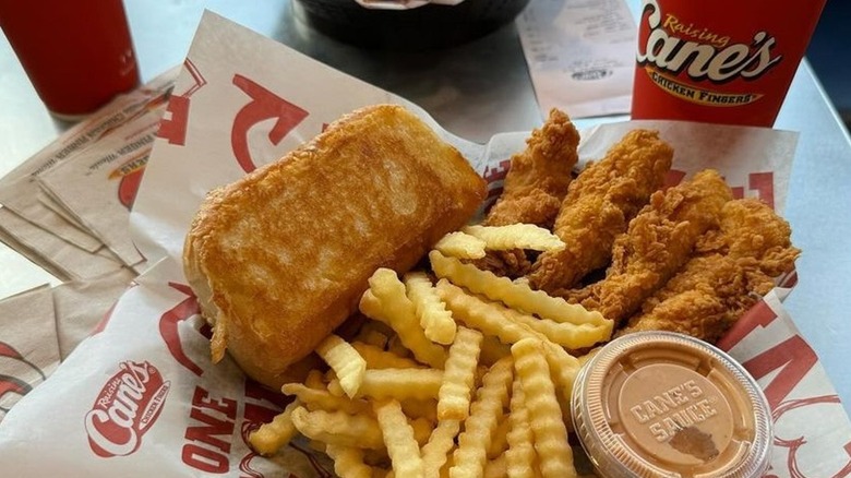 Raising Cane's fries are part of a meal deal sitting on a table.