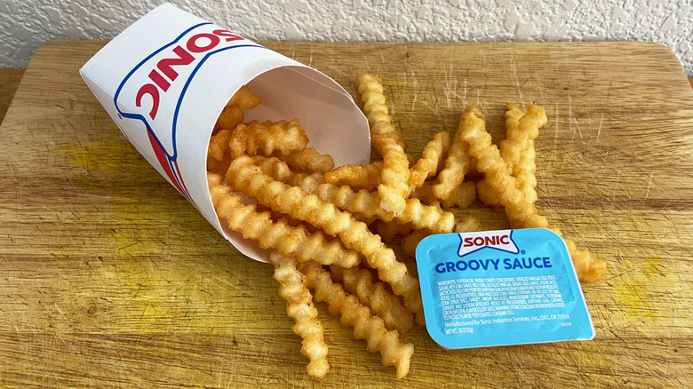 Sonic Drive-In fries with sauce are on a table.