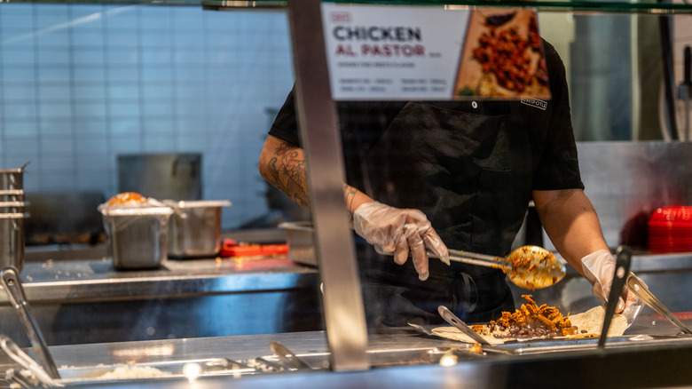 employee making burrito at Chipotle