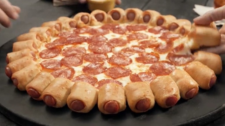 Hot dog bites pizza being served