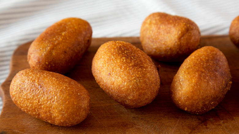 Mini corn dogs on wood platter