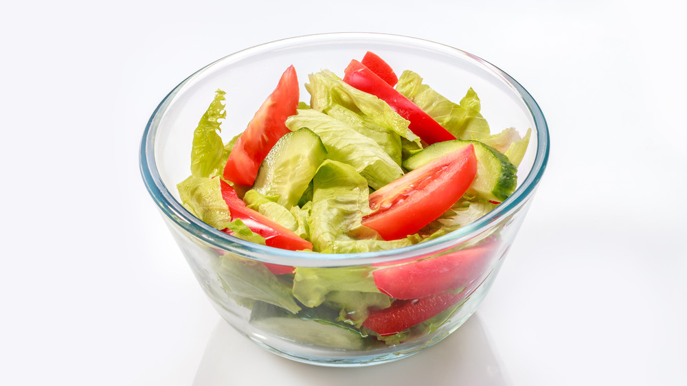 A small side salad in a glass bowl